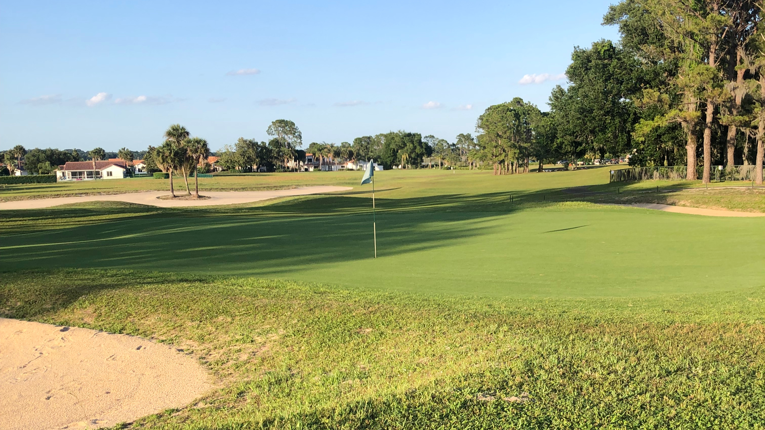 Flag on golf course with bunkers
